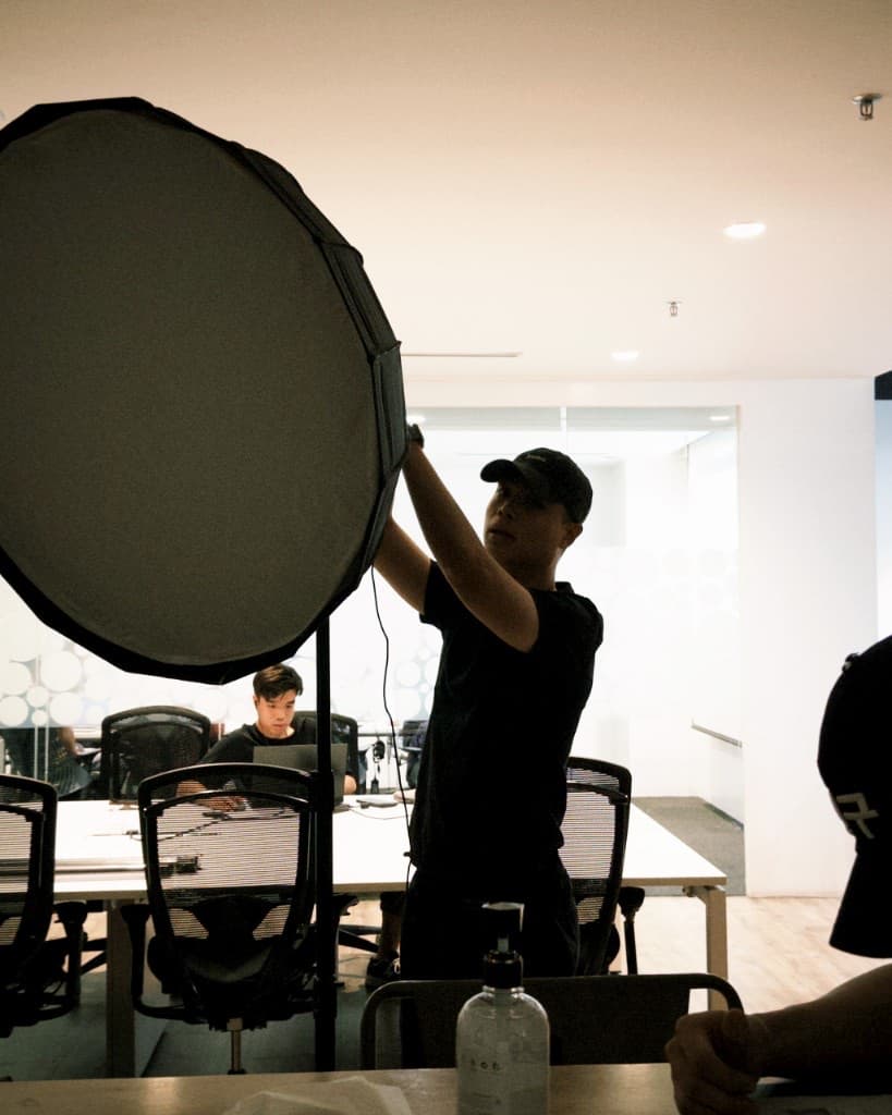 Person Edge team setting up studio lighting